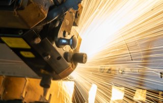 Image of a CNC machine cutting a sheet of metal